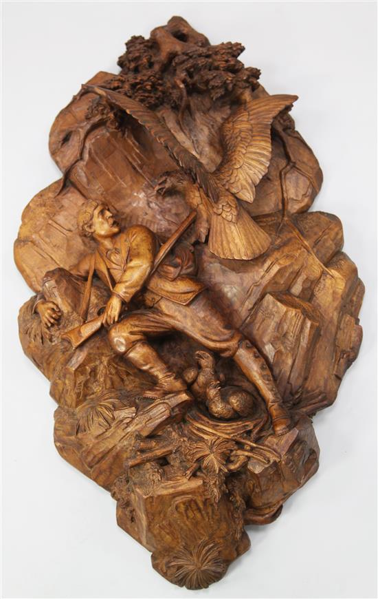 Johann Huggler, Brienz (Swiss 1834-1912). A Black Forest carved linden wood wall plaque, W.1ft 10in. H.3ft 2in.